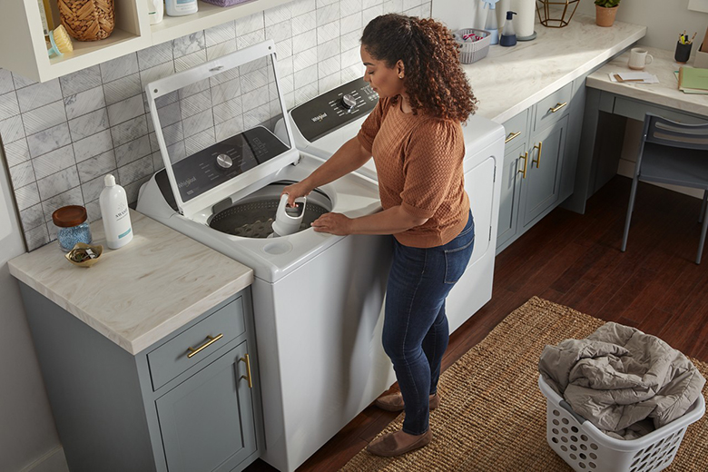 Female putting detergent in Washer