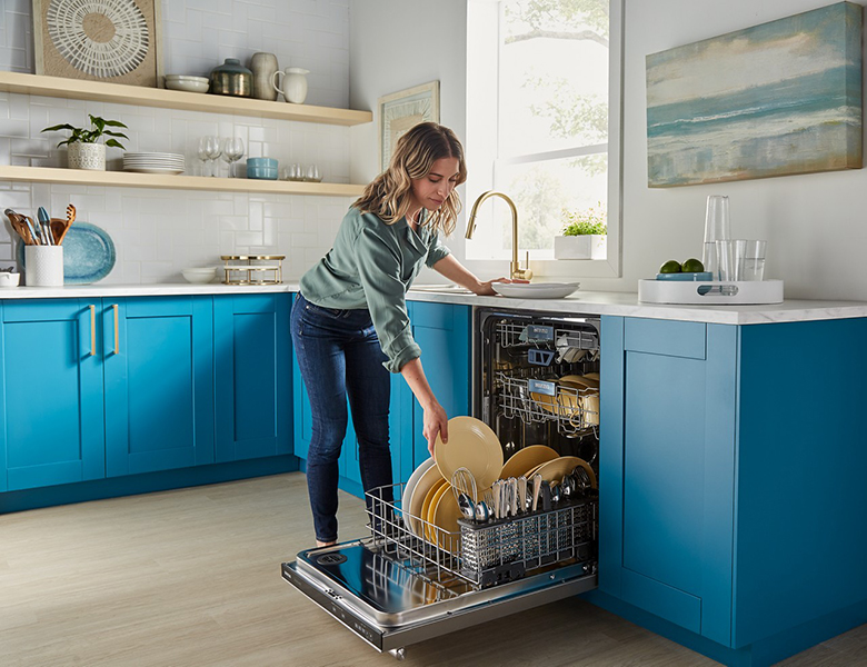 Female Putting Dishes in Dishwasher